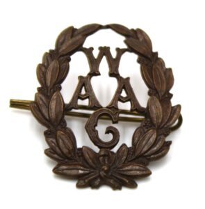 Image of a metal badge with a the name WAAC detailed in the centre