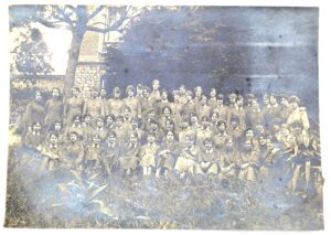 Black and white photograph of a large group of young women dressed in uniform.